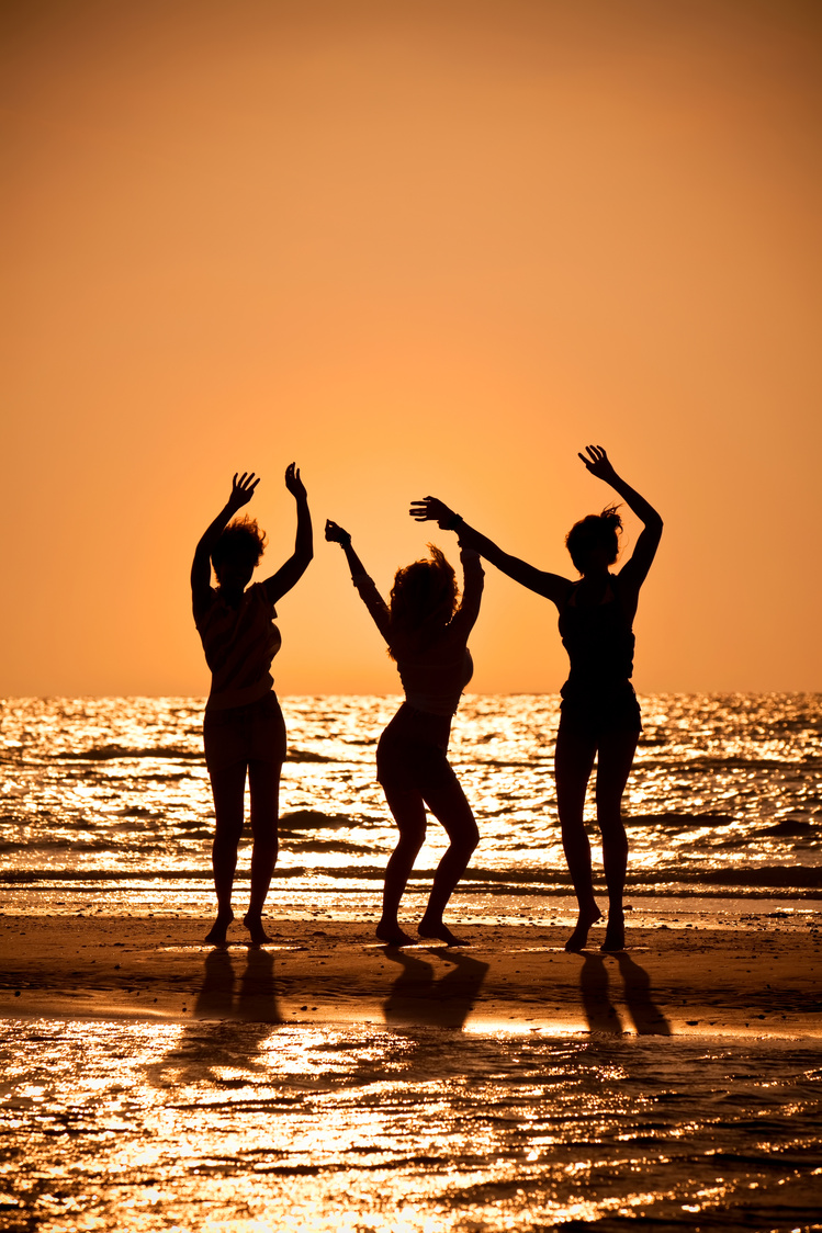 Three Young Women Dancing on Beach 